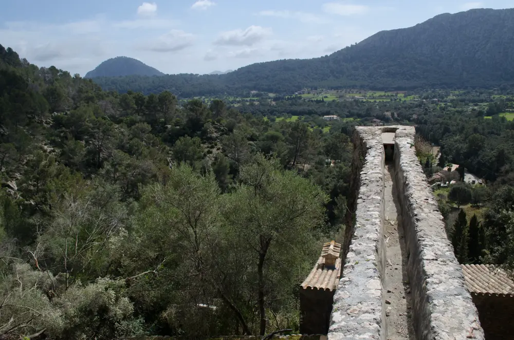 Panorama-Ausblick auf die ländliche Landschaft von Pollença, Mallorca, mit einer alten Steinstruktur im Vordergrund, ideal für Wanderungen. Perfekt zum Wandern mit Kindern, Molins de Llinares.